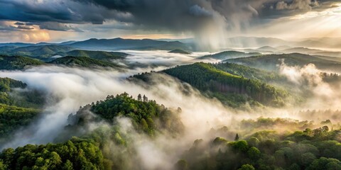 Fototapeta premium Aerial view of heavy rain creating a misty veil over rolling hills and dense forests
