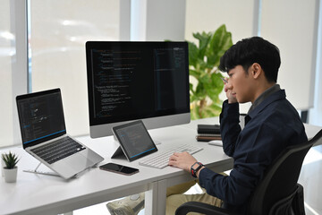 Overwhelmed Programmer Managing Complex Code, Stressed Software Developer at Desk