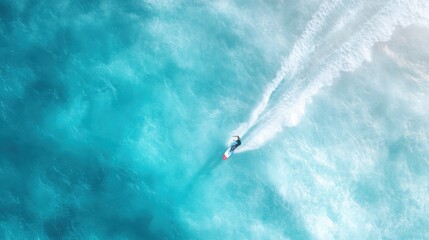 Aerial view of solo wakeboarder gliding across ocean surface