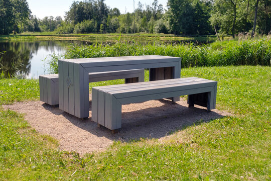 Empty bench in the park with pond