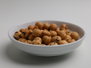 Fried coated peanut on white bowl