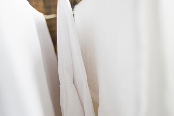 Washed white clothes on a hanger.