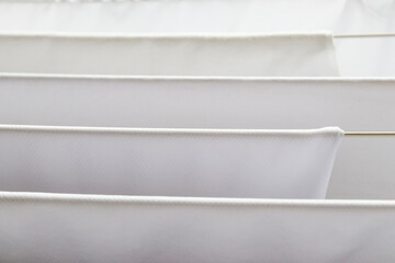 Washed white clothes on a hanger.