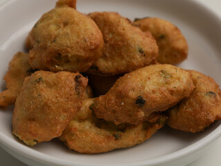 Tofu fritters, piled on white plate