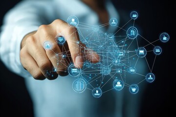 Close-up of hand interacting with a glowing futuristic digital network interface displaying interconnected icons and data points in a dark environment