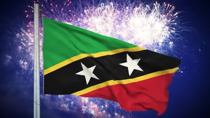 A national flag of Saint Kitts and Nevis billows proudly against a vibrant backdrop of fireworks.