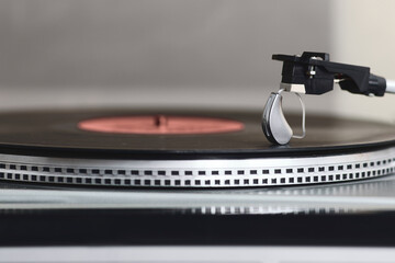 Hearing aid sits next to a vinyl record, highlighting the link between sound and health in music