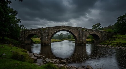 Fototapeta premium Stone bridge emerging during stormy evening, stone walls weathered
