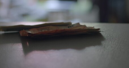 A detailed sequence of images that vividly showcases the process of cash being meticulously handled on a table, effectively illustrating a financial transaction process in action - Powered by Adobe