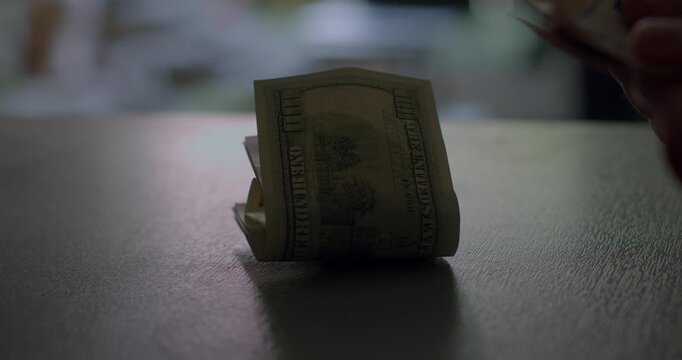 Closeup shots of various bills being exchanged on a table, effectively capturing the fine details of currency transactions, along with hands actively involved in the exchange process - Powered by Adobe