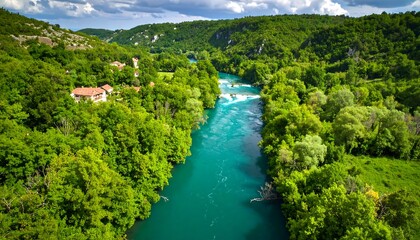 Obraz premium Lush green valley with turquoise river