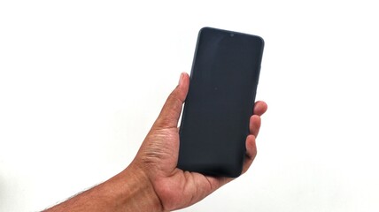 A close-up of a hand holding a smartphone, with a subtly blurred background suggesting an everyday setting. This image captures the common interaction with mobile devices.
