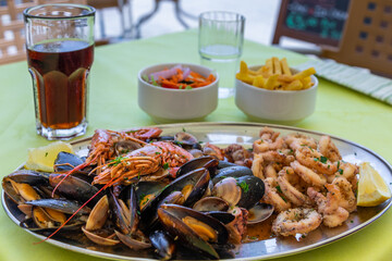 Seafood platter with fried calamari and mussels in Marsaxlokk.