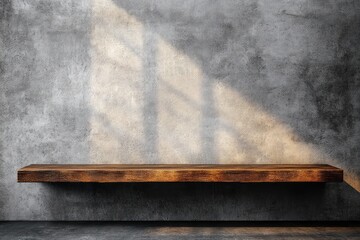 Empty wooden floating shelf mounted on a textured concrete wall with sunlight casting window shadows