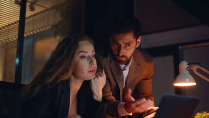 Portrait stressed colleagues overtime work solving problem at night workplace