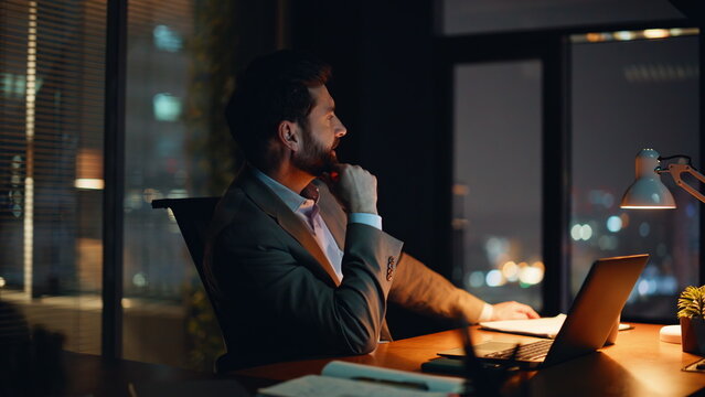 Entrepreneur thinking success late evening office closeup. Manager pondering