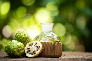 Noni is extracted with coconut oil and used for hair care on natural background.