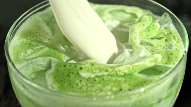 Super Slow Motion Detail Shot of Pouring Cream into Matcha Latte with Camera Motion at 1000fps.