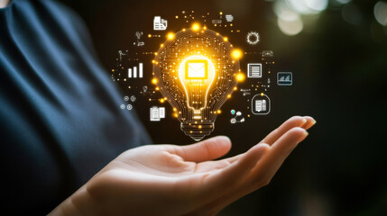 Innovative tech concept with glowing light bulb and hand representing ideas and creativity in modern business