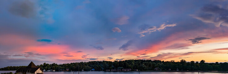 Orange and pink fan clouds scatter. Calm blue evening sky. Wide panoramic view. Fresh air volume background. Space of steam soft quiet panorama. Evening cloudy sunset. Banner with copy space.