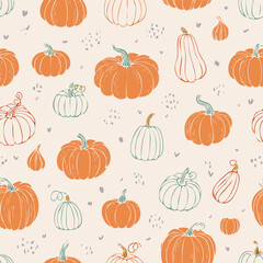 Seamless autumn pattern with orange pumpkins, green leaves, and decorative dots. Cozy seasonal design perfect for fall, Thanksgiving, and harvest themes