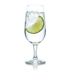 Refreshing gin and tonic cocktail with a lime slice in a delicate glass on a white background, isolated