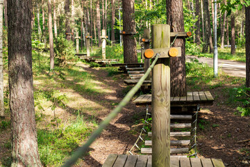 Experience a thrilling tree climbing park designed for adventure enthusiasts, featuring wooden structures and rope pathways nestled in lush greenery. This natural setting invites exploration