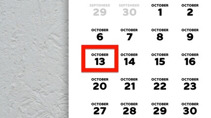 Close-up of the date October 13th marked with a red cursor on the wall calendar 2025