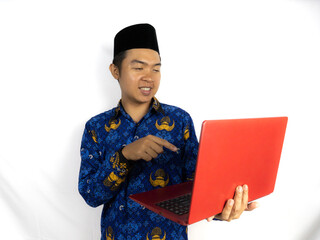 Happy Indonesian government worker men wearing blue batik uniform, holding and pointing to the...