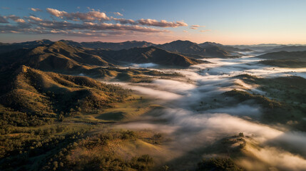 A foggy mountain range with a misty valley in the foreground