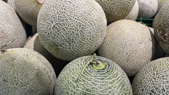 A close-up shot of a pile of cantaloupe melons.