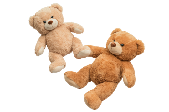 Two adorable plush teddy bears, one light brown and one darker brown, are shown lying down against a transparent background. background removed