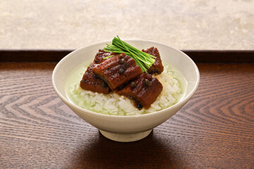 Hot green tea is poured over cooked rice topped with eel simmered in sweetened soy sauce. Japanese cuisine