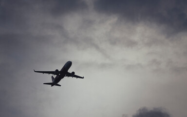 Airplane taking off in gloomy day