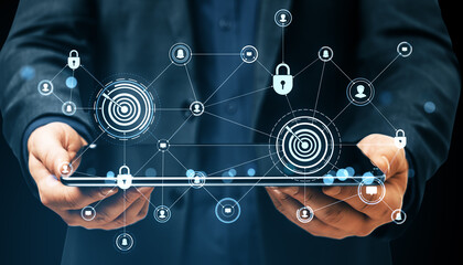 Businessman holding tablet with digital padlock symbols and secure network interface icons on dark background representing cyber data protection.