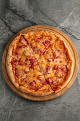 Freshly baked pizza with golden crust, melted cheese, and assorted toppings. Hot and delicious Italian dish served straight from the oven