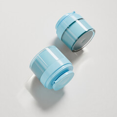 Small cosmetic pump bottle mockup, trendy blue skincare pump packaging, short cylindrical cream jar packaging with airless pump dispenser, glossy acrylic facial moisturizer vacuum bottle mockup