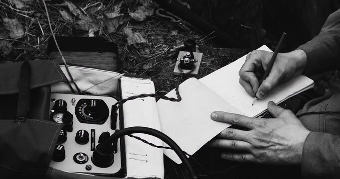 Historical Re-enactment Black And White Video. Russian Soviet Infantry Red Army Soldier In World War II using Russian Soviet Portable Radio Transceiver In Trench Entrenchment In Spring Autumn Forest