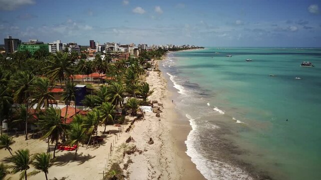 Aerial drone view of Cabedelo Beach with turquoise ocean and white sand, Para&iacute;ba, Brazil