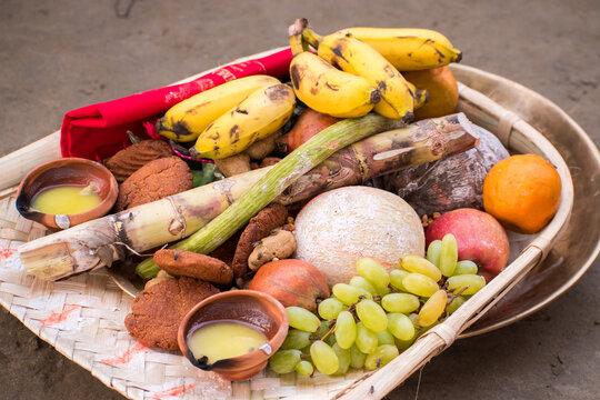 Chhath puja Celebration, traditional bamboo dala filled with Chhath Puja offerings including bananas, thekua, sugarcane, diya (earthen lamp), and other ritual items prepared for worship of the Sun God