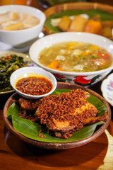 Crispy Fried Kampung Chicken (Free-Range), captured on September 1, 2025. Golden brown Indonesian dish on rustic plate, authentic homemade flavor, traditional culinary heritage