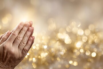 Praying hands with golden bokeh background representing hope and faith