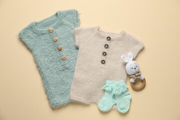 Stylish baby clothes and accessories on beige background, flat lay