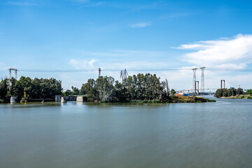 Obraz premium Centenario Bridge and high-voltage lines over Guadalquivir