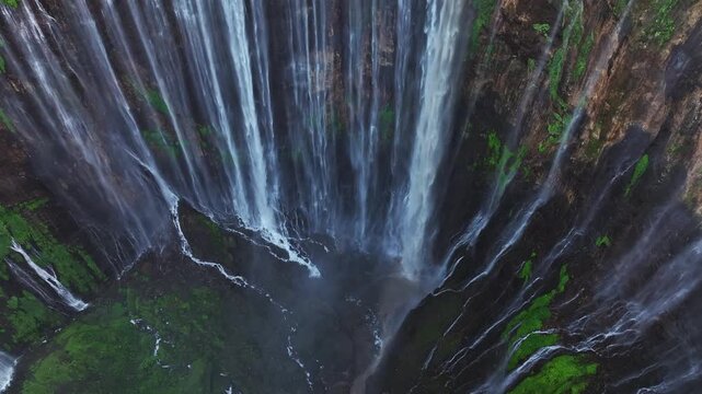 Aerial view  rise up to reveal Tumpak Sewu waterfall, East Java, Indonesia