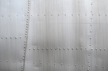 Close-up of the skin of a light aircraft, rivets on duralumin. Concept of aircraft modeling, aircraft maintenance, development of aviation technology, regulations