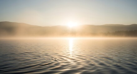Obraz premium Sunrise Over Misty Lake with Rippling Water.