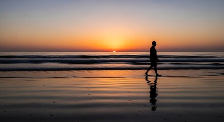 Fototapeta premium Silhouette on Beach at Sunset.