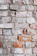 Rustic old brick wall with weathered texture and crumbling cement.