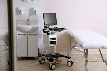 Modern ultrasound machine, sink and examination bed in clinic